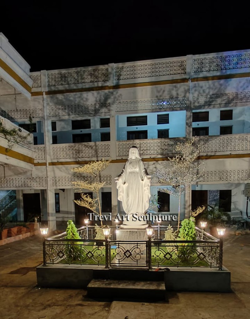 pair the mary statue with lighting and iron fencing