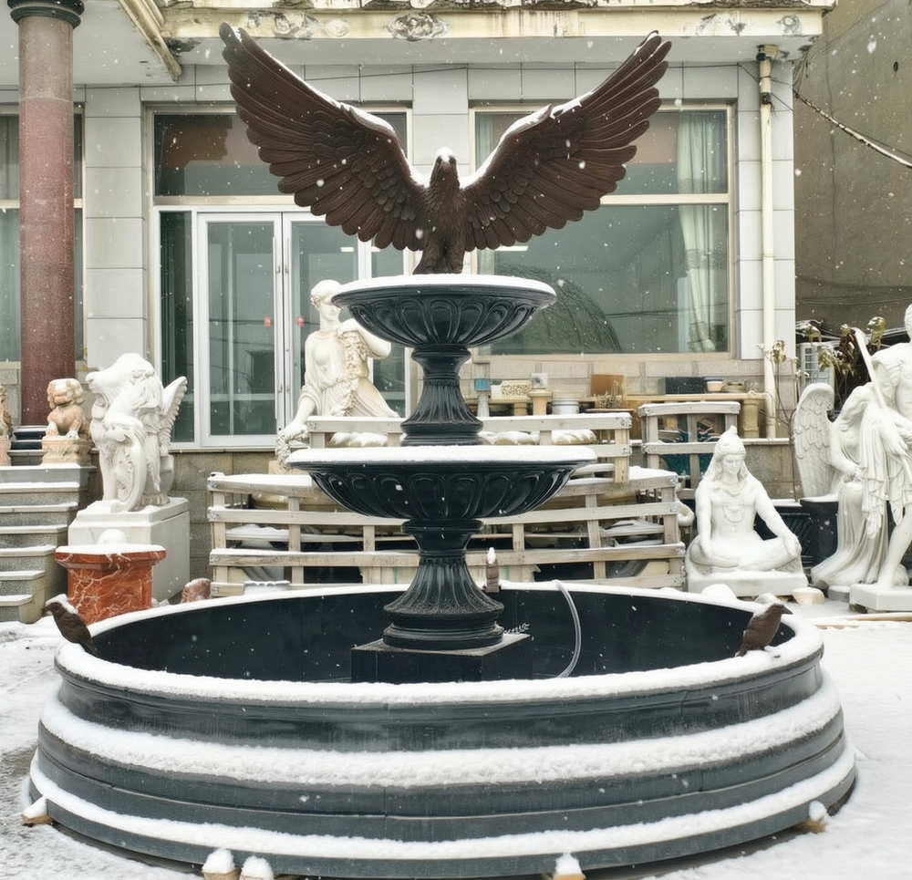 outdoor large garden black fountain in snow