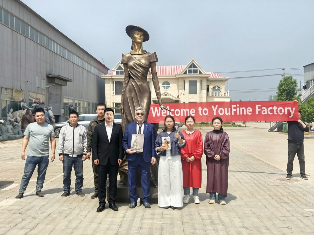 A Group Photo of the YouFine Factory Artisans, Mr. Berlin Irishev, and the Sculpture
