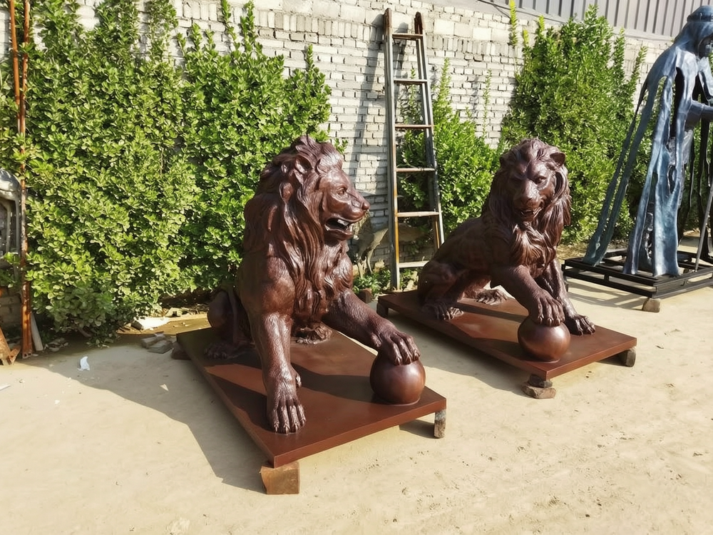 bronze lion with ball statue
