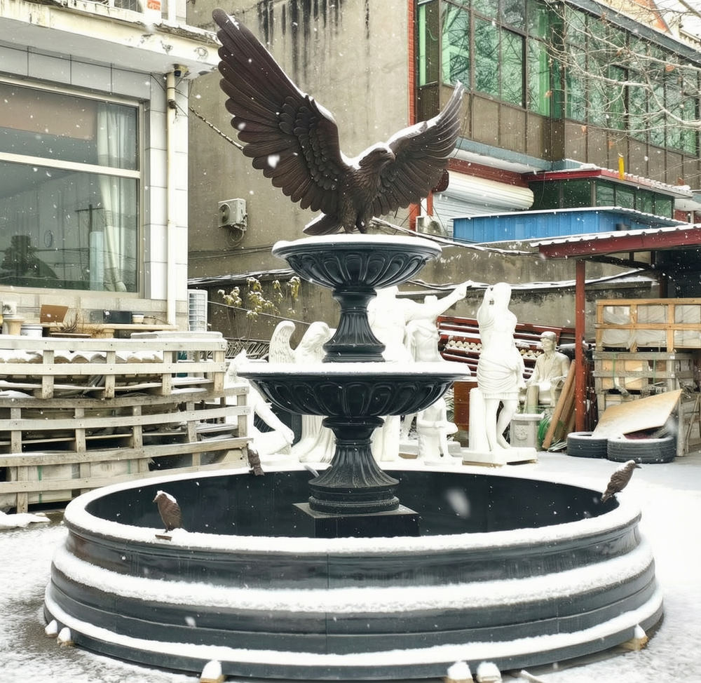 outdoor large garden black marble fountain in snow